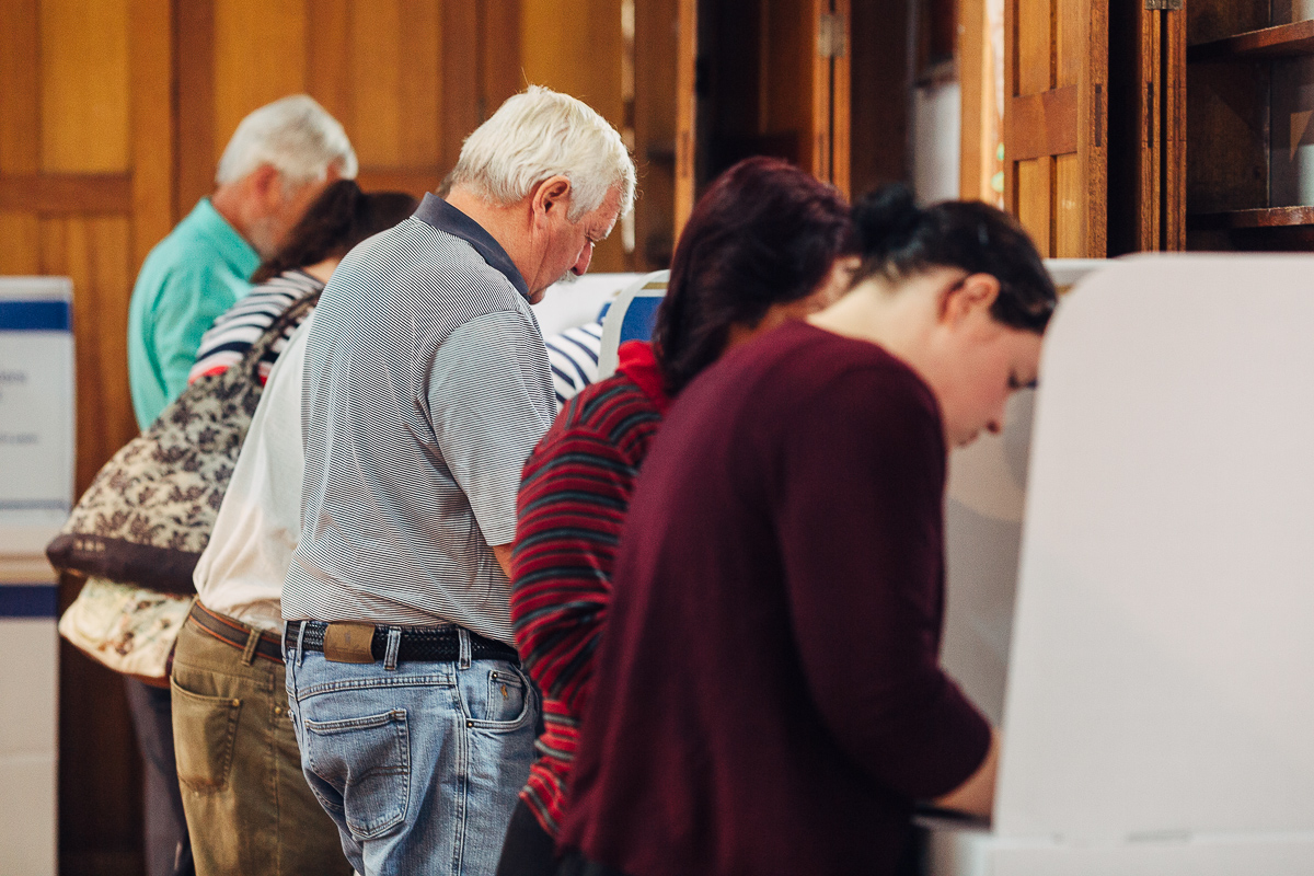 Voters filling in their ballot paper in private voting screens