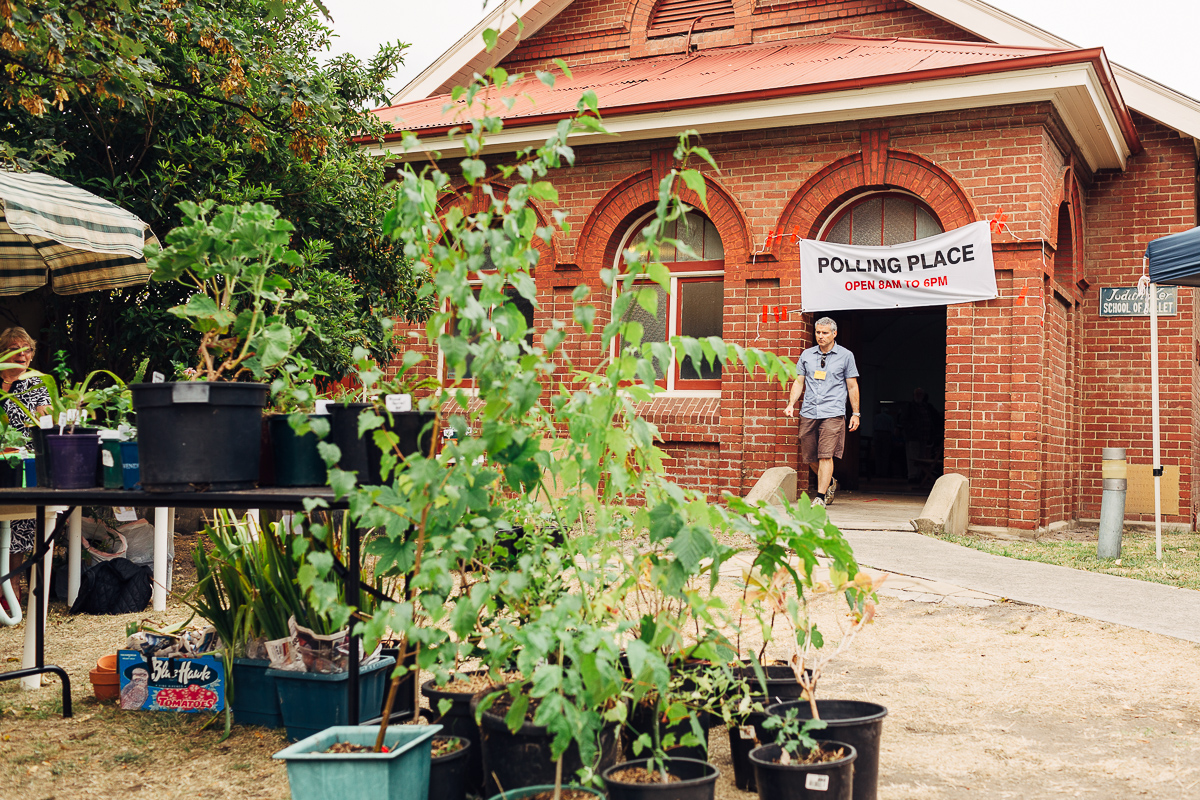 A community market selling plants outside the entrance to a polling place adds to the polling atmosphere