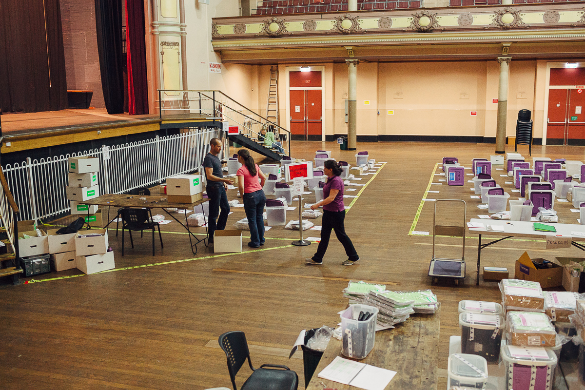 Electoral staff sorting and organising materials at the Hobart Town Hall as it's returned from each polling place