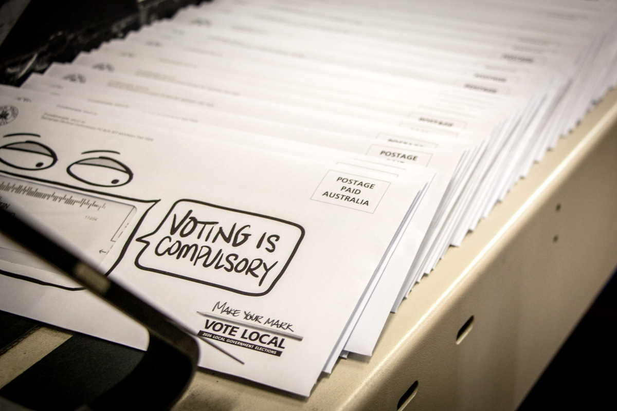 Close up of ballot pack envelopes being sorted in a warehouse