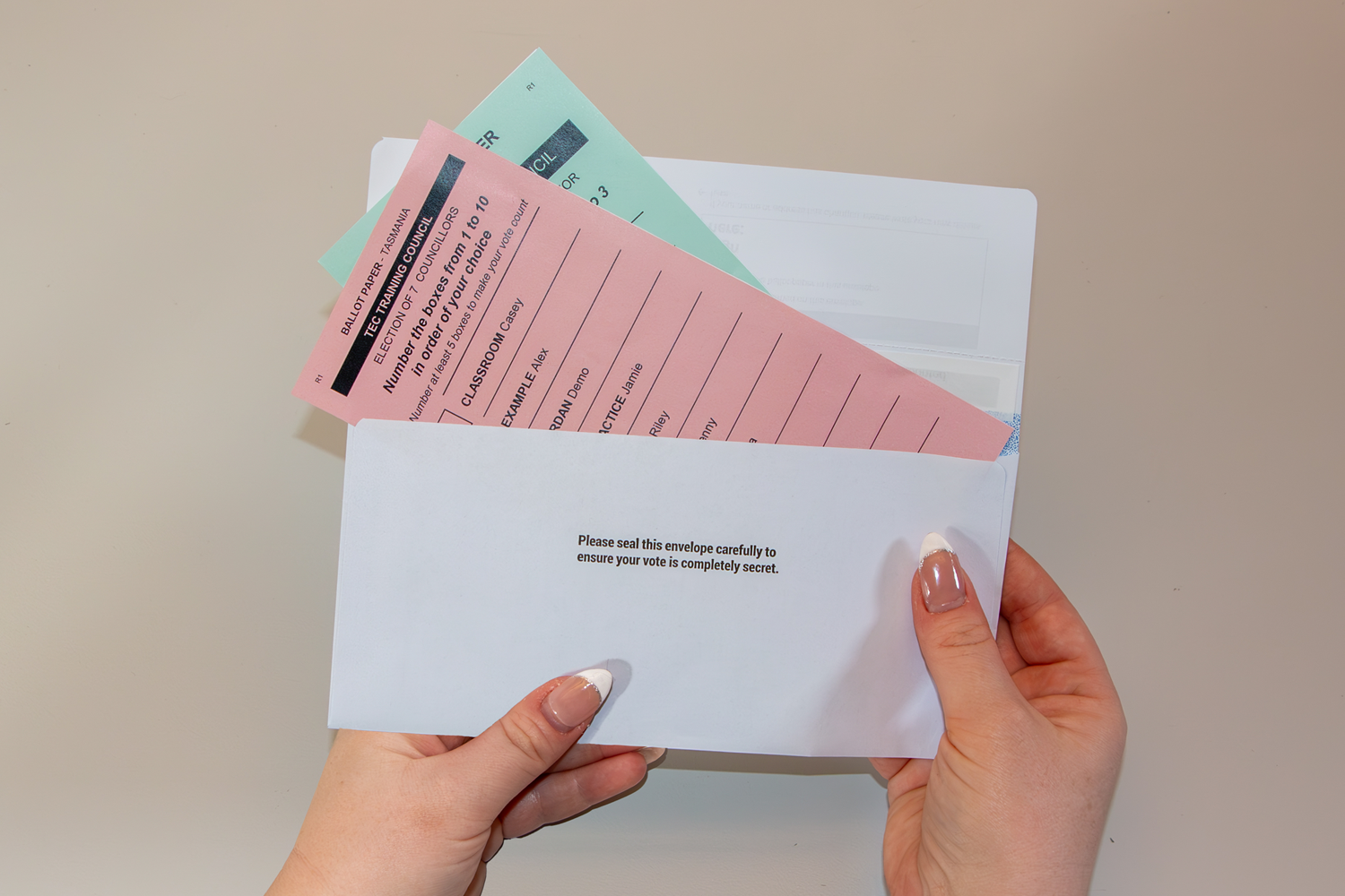 Completed ballot papers being placed in the ballot paper envelope