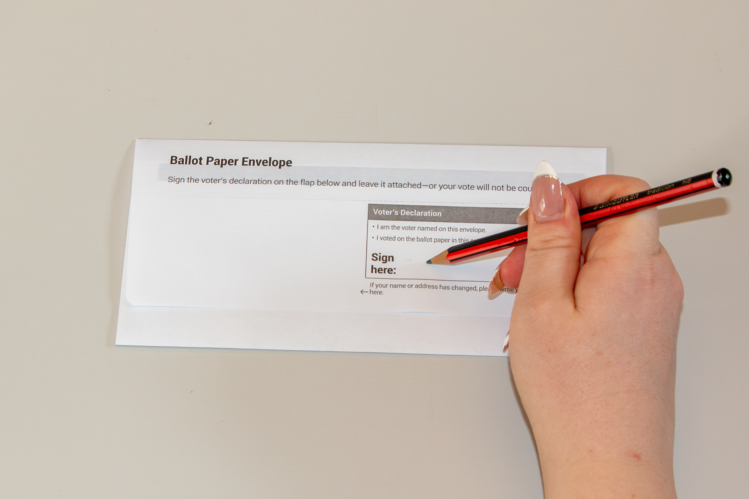 Ballot paper envelope being signed