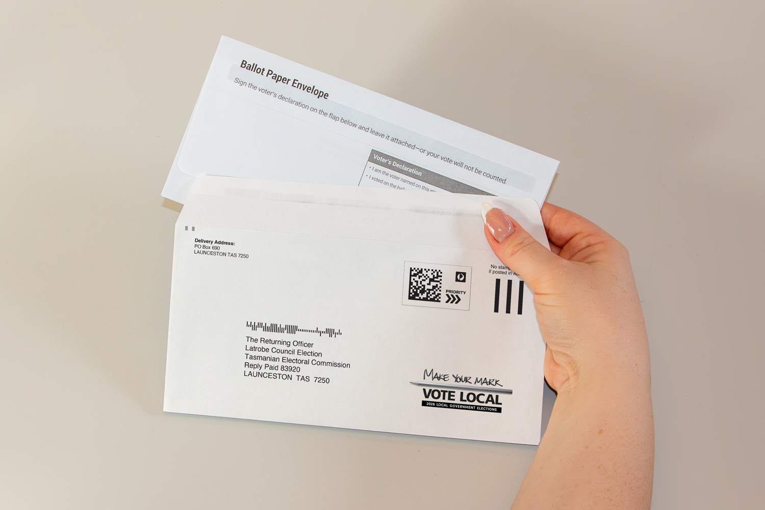 Ballot paper envelope being placed inside the Reply Paid envelope