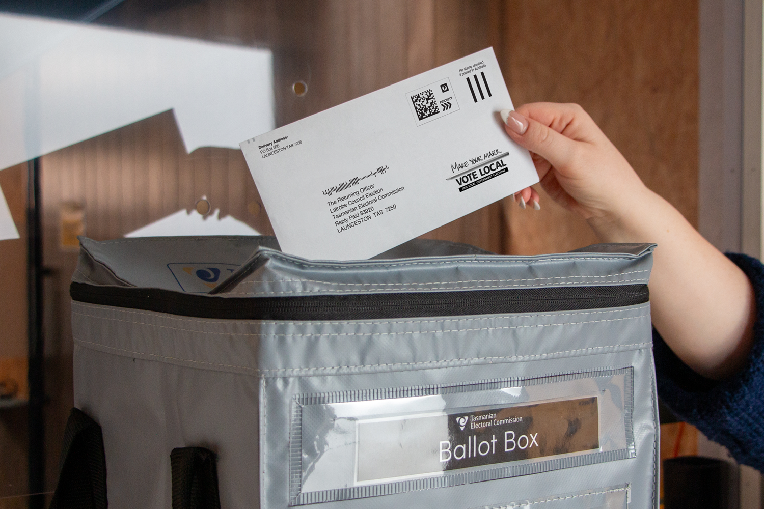 Reply Paid envelope being placed in a council ballot box