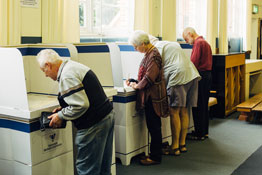 Row of voting screens occupied by voters