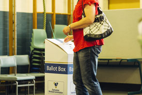 Person placing ballot paper in ballot box